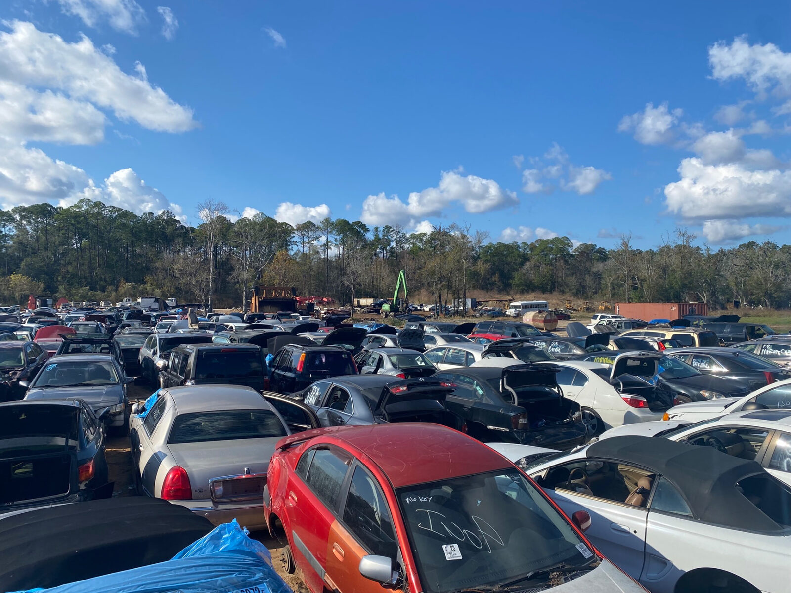 Used cars and trucks parked in the A A Autoparts Jacksonville yard